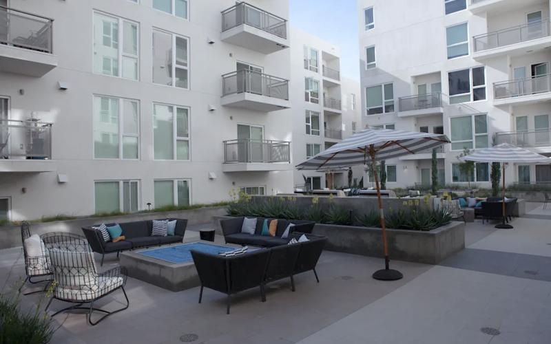 a courtyard with couches, tables and chairs
