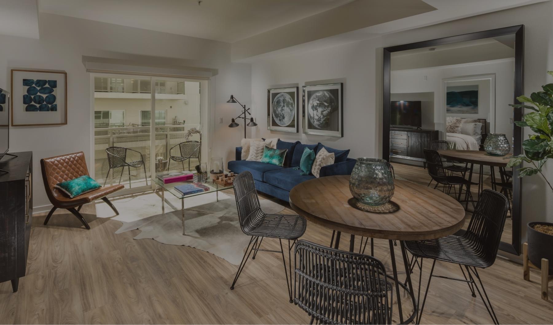 a living room with a couch, table and chairs