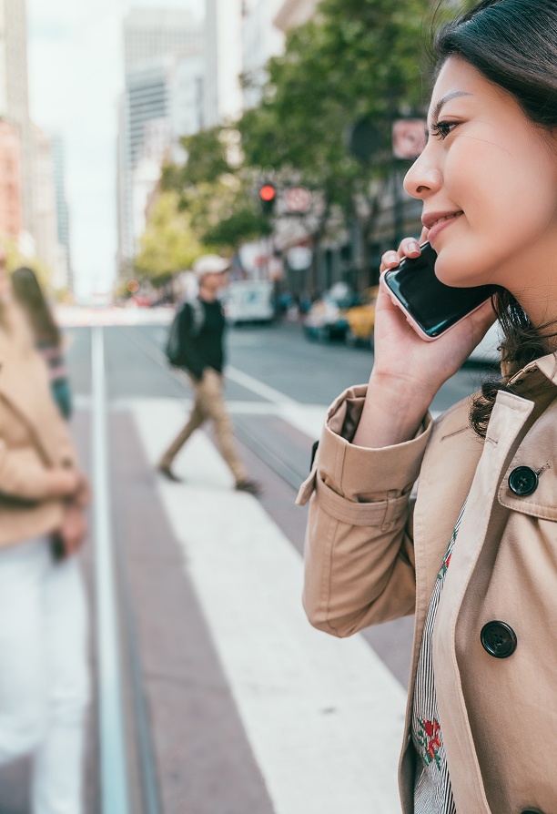 Woman walking through city on the phone