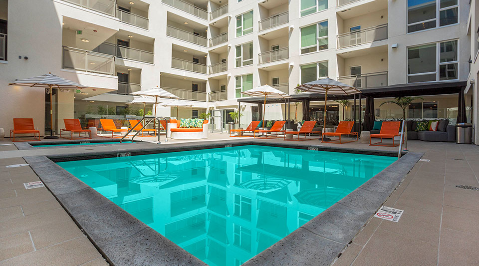 Glendale CA Apartments for Rent - ONYX Glendale - Outdoor Square Shaped Pool With Comfy Lounge Chairs